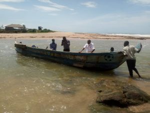 Volunteers in Canoe to Adjoa Village